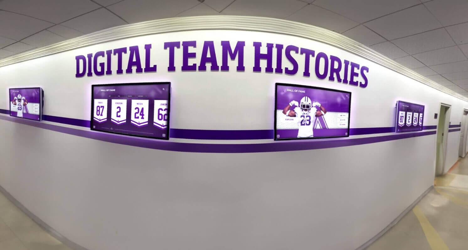 School hallway featuring digital team history displays School hallway with digital displays
