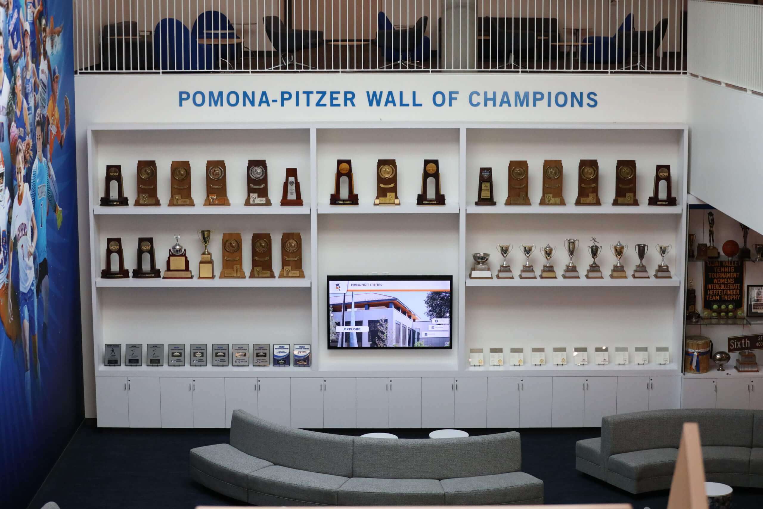 School lounge area with wall of champions trophy display School lounge with recognition wall