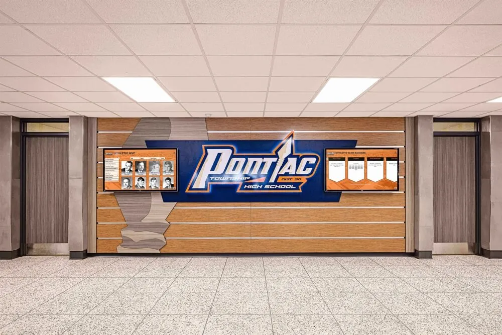 School hallway featuring athletic honor wall displays School entrance with recognition displays